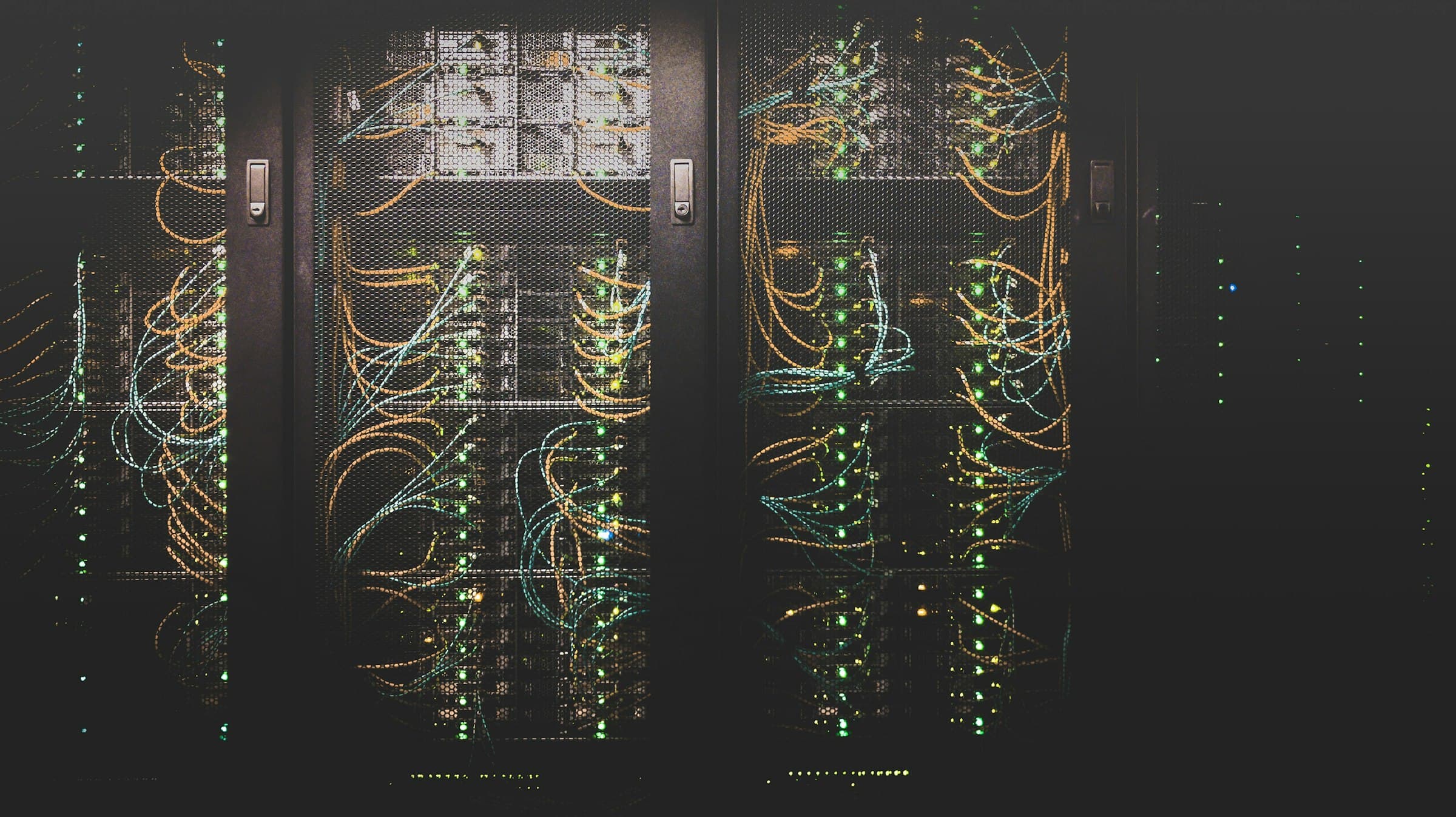 Managed hosting — server racks lit by cool blue indicator lights in a data center
