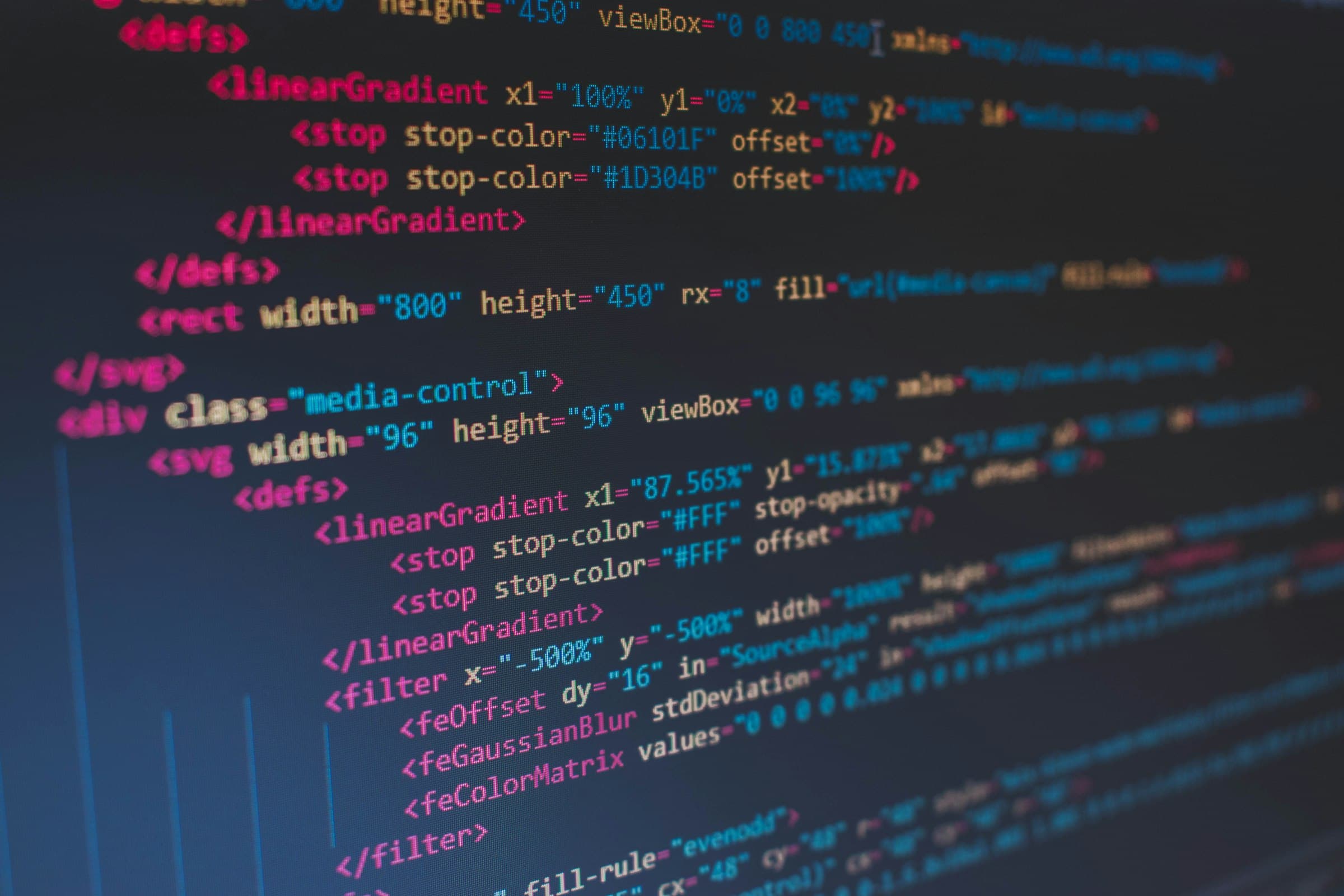 Why Next.js over WordPress — laptop displaying source code on a dark background